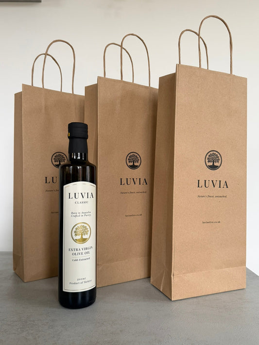 Premium LUVIA Turkish olive oil bottle with kraft paper gift bags for gifting.